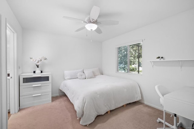 bedroom featuring baseboards, ceiling fan, and light colored carpet