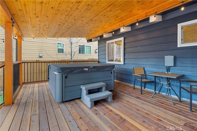 wooden terrace with a hot tub