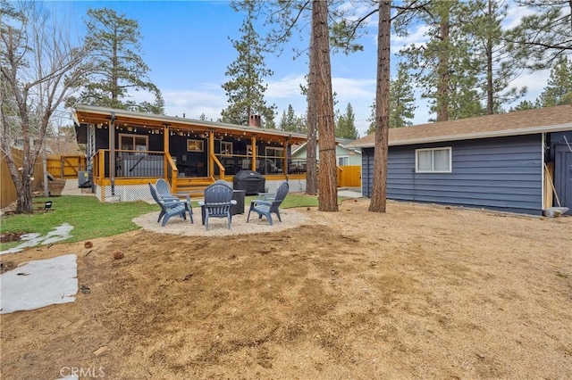 back of property featuring an outdoor fire pit, fence, a chimney, and a patio