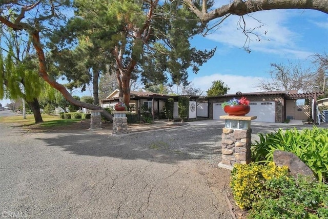 view of front of house featuring aphalt driveway and an attached garage