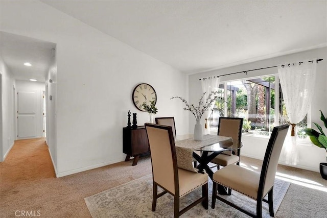 dining room with light carpet and baseboards