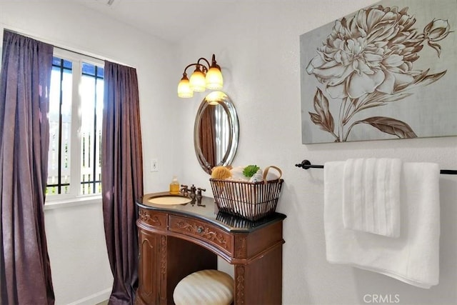 bathroom with plenty of natural light, vanity, and baseboards