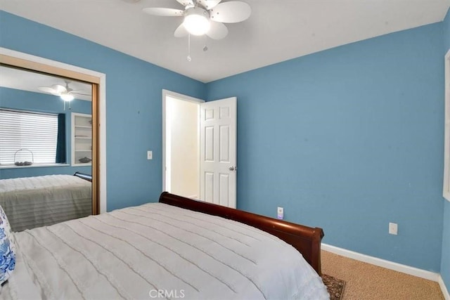 bedroom featuring a ceiling fan, a closet, baseboards, and carpet flooring