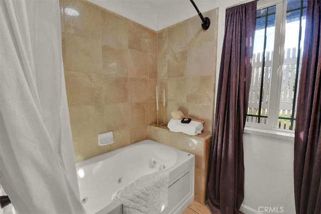 full bath with a combined bath / shower with jetted tub and tile walls