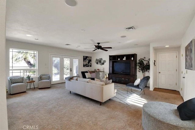 living room featuring light carpet, visible vents, a ceiling fan, french doors, and recessed lighting