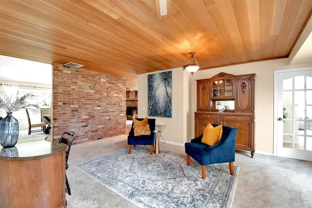 sitting room featuring wood ceiling, light carpet, baseboards, and brick wall