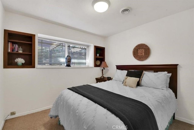 bedroom with carpet floors, visible vents, and baseboards