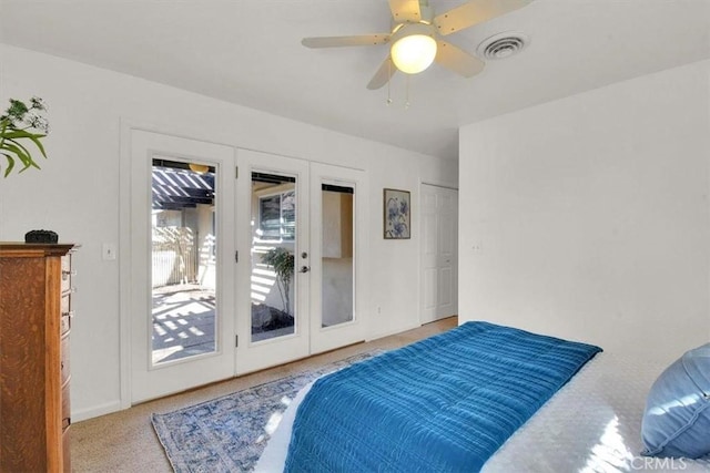 bedroom with access to outside, carpet floors, visible vents, and a ceiling fan