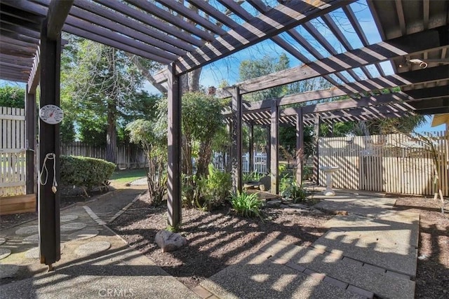 view of patio featuring fence and a pergola