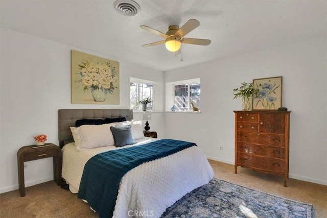 bedroom with ceiling fan, carpet floors, visible vents, and baseboards