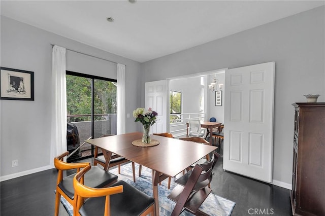 dining space with a notable chandelier and baseboards