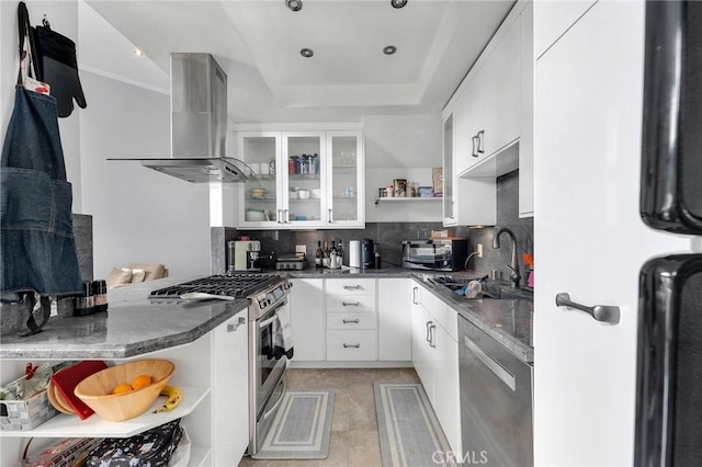 kitchen with stainless steel appliances, island range hood, open shelves, and decorative backsplash