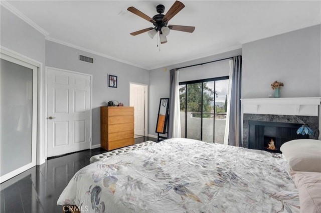 bedroom featuring crown molding, visible vents, a premium fireplace, wood finished floors, and access to outside