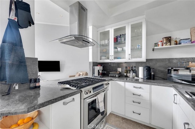 kitchen featuring stainless steel gas stove, glass insert cabinets, white cabinetry, and island range hood