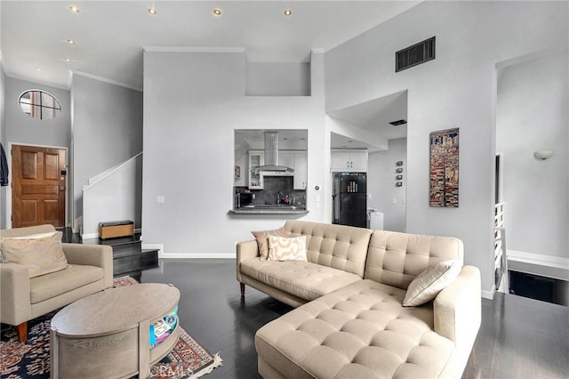 living room with recessed lighting, dark wood-type flooring, visible vents, baseboards, and ornamental molding