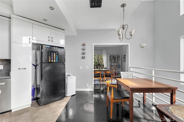 dining space with an inviting chandelier, baseboards, light tile patterned floors, and visible vents