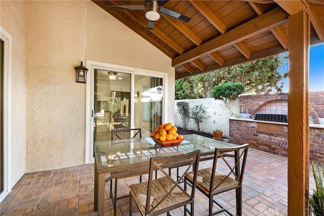 view of patio / terrace with outdoor dining space, fence, and a ceiling fan