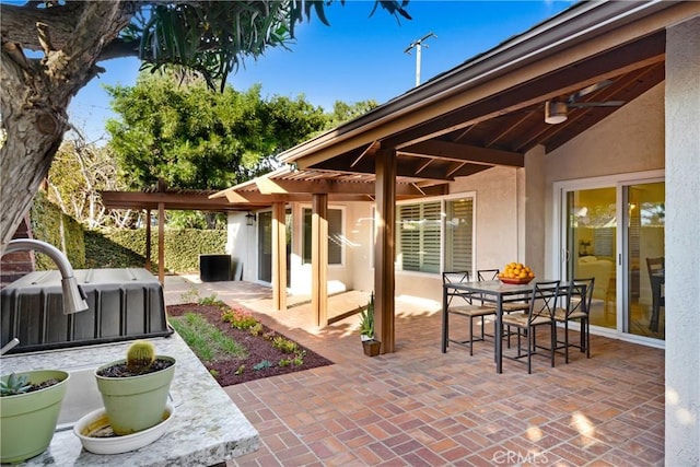 view of patio / terrace featuring outdoor dining area, a hot tub, ceiling fan, fence, and a pergola