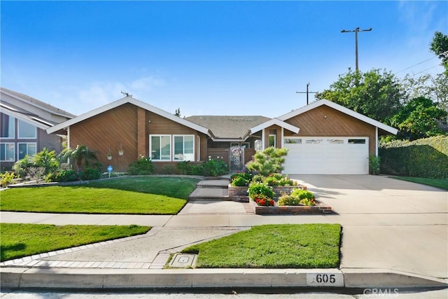 view of front of property with a garage, concrete driveway, and a front yard