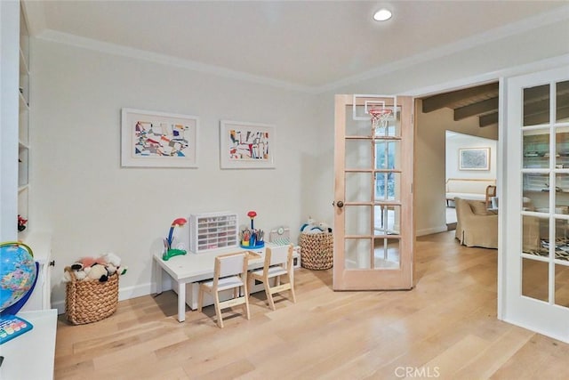 rec room featuring french doors, crown molding, recessed lighting, light wood-style floors, and baseboards