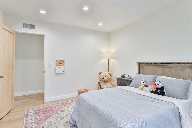 bedroom with recessed lighting, visible vents, light wood-style flooring, and baseboards