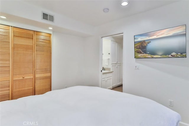 bedroom featuring recessed lighting, a closet, visible vents, and ensuite bathroom