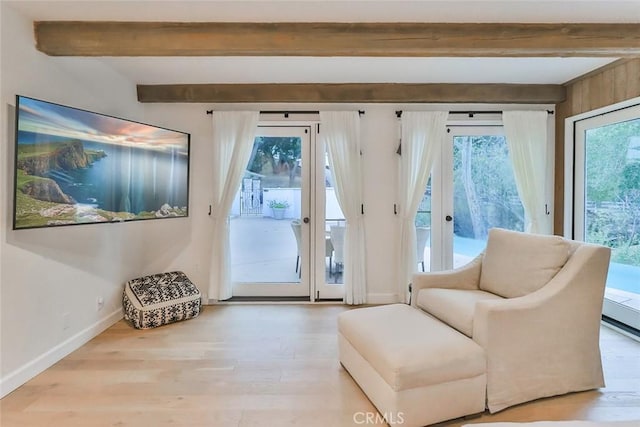 entryway with french doors, beamed ceiling, baseboards, and wood finished floors