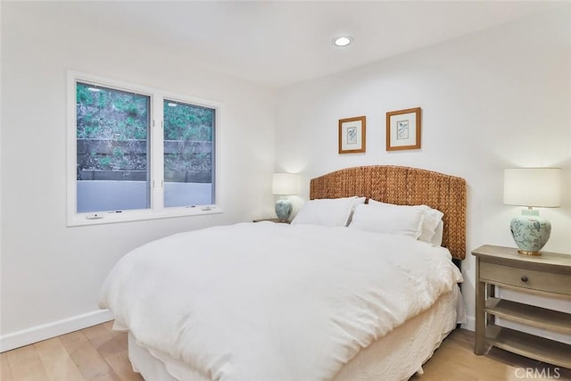 bedroom with recessed lighting, light wood-style flooring, and baseboards