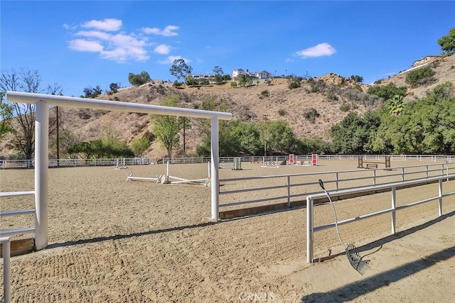 view of community featuring an enclosed area and a rural view