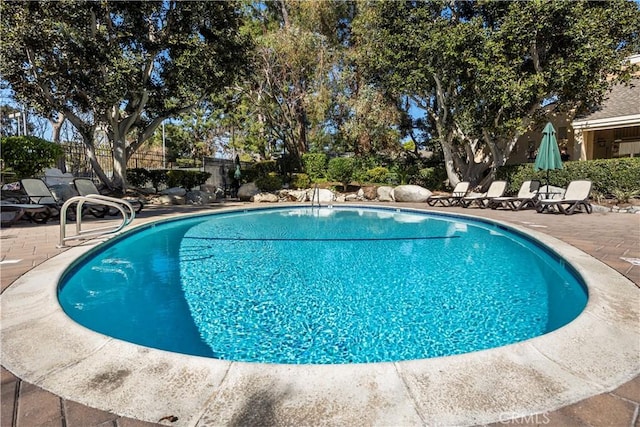 view of pool with a fenced in pool, a patio area, and fence