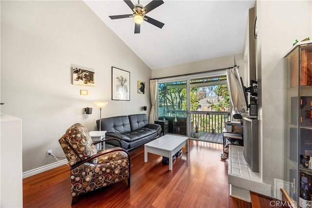 living room featuring a ceiling fan, high vaulted ceiling, baseboards, and wood finished floors