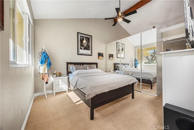 bedroom featuring lofted ceiling, baseboards, multiple windows, and carpet