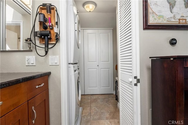 interior space featuring stacked washer / drying machine and vanity