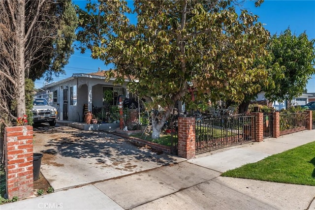 obstructed view of property featuring stucco siding, driveway, and fence