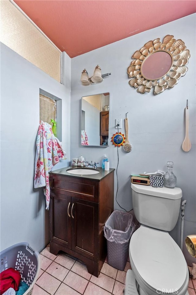 half bath with tile patterned flooring, toilet, and vanity