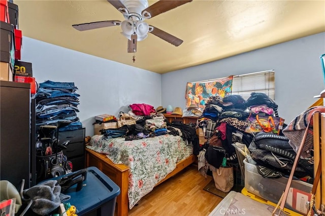 bedroom with light wood-type flooring and a ceiling fan