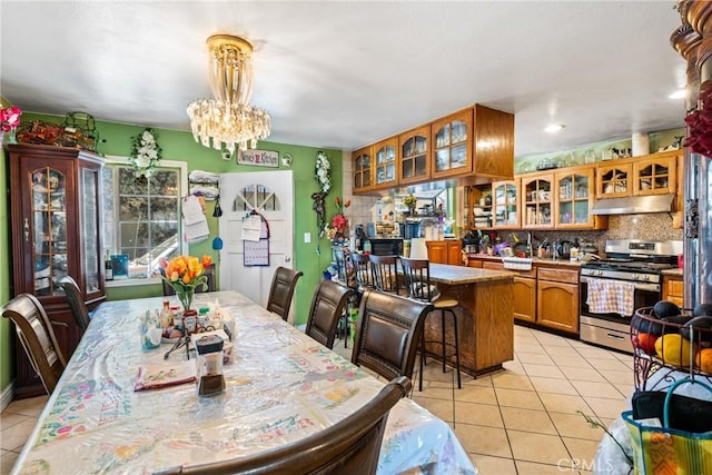 dining area with light tile patterned floors and a notable chandelier