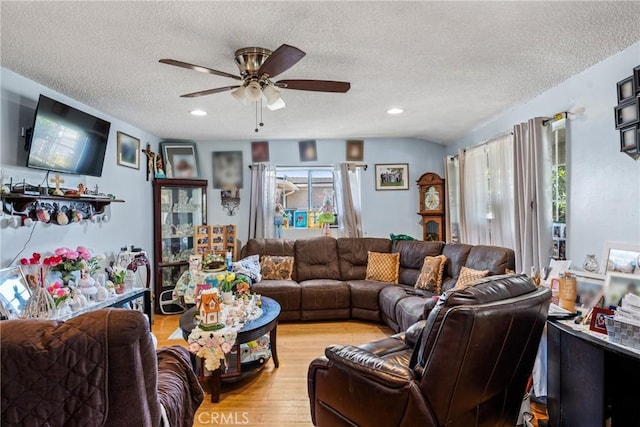 living room featuring recessed lighting, a textured ceiling, ceiling fan, and light wood finished floors