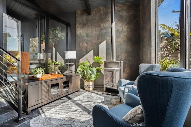 sunroom / solarium with a wood stove and beamed ceiling