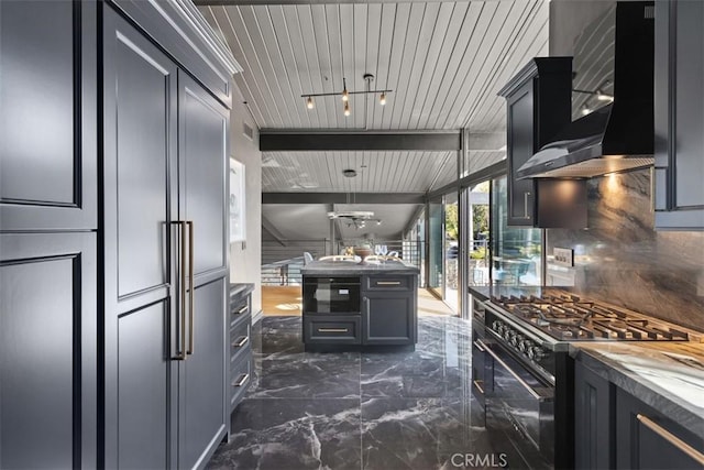 kitchen with wall chimney exhaust hood, backsplash, high end black range oven, marble finish floor, and beam ceiling