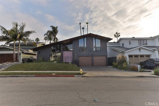 view of front of property with a garage, driveway, and metal roof