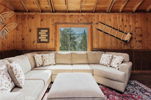 living room with wood walls, wood ceiling, beamed ceiling, and wood finished floors