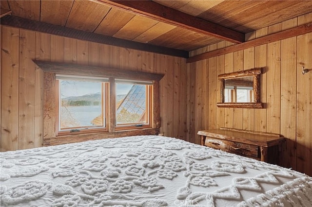 unfurnished bedroom featuring wood walls, wood ceiling, and beamed ceiling