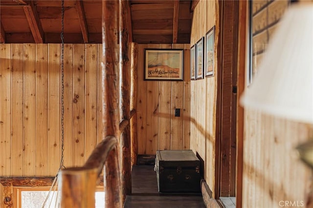 hallway featuring wooden ceiling and wood walls