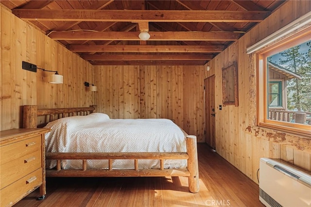 bedroom with wooden ceiling, wood walls, lofted ceiling with beams, and hardwood / wood-style floors