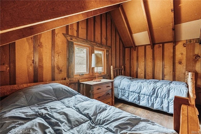 bedroom featuring lofted ceiling and wood finished floors