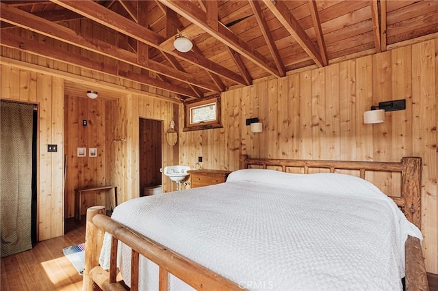 bedroom with lofted ceiling with beams, wooden ceiling, wooden walls, and hardwood / wood-style floors