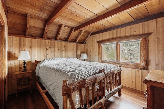 bedroom with vaulted ceiling with beams, wooden ceiling, wooden walls, and wood finished floors