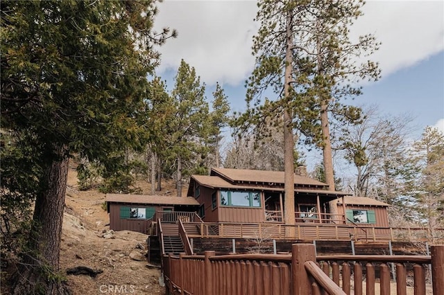 view of front of property with stairway and a wooden deck