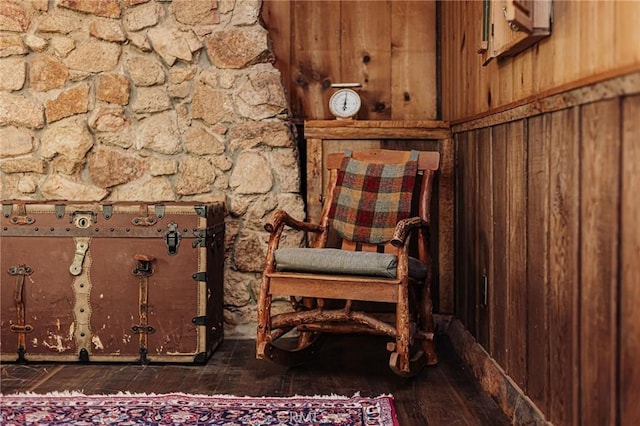 unfurnished room with wood-type flooring and wooden walls